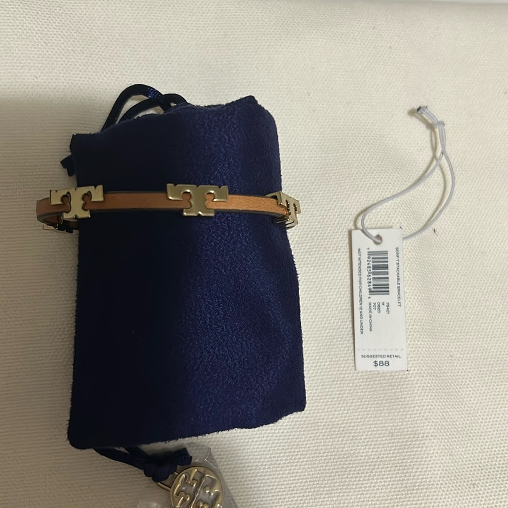 Tory Burch Serif-T tan leather band bracelet.
